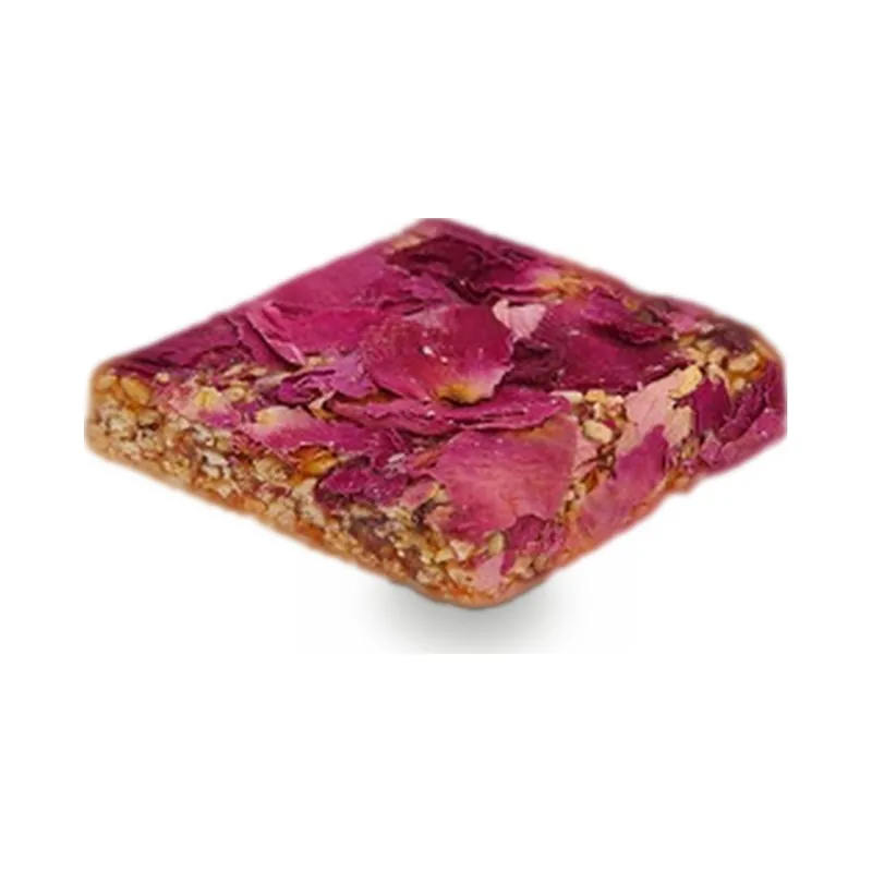 A thin chocolate slab topped with dried rose petals and pistachio