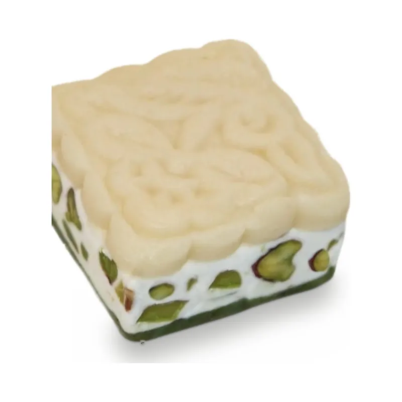 A square of white nougat with pistachios
