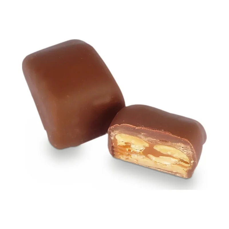 Two milk chocolate bonbons, one cut to show its filling