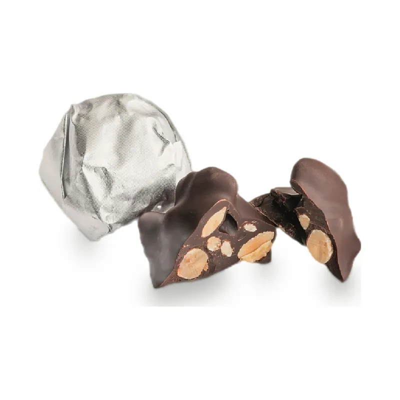 Dark chocolate pieces with whole almonds, one wrapped in silver foil