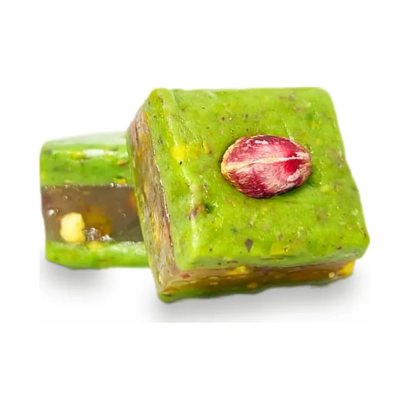 A green pistachio square topped with a dried rosebud
