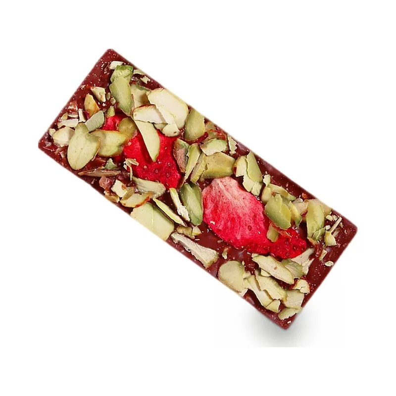 A chocolate bar topped with dried strawberries and seeds