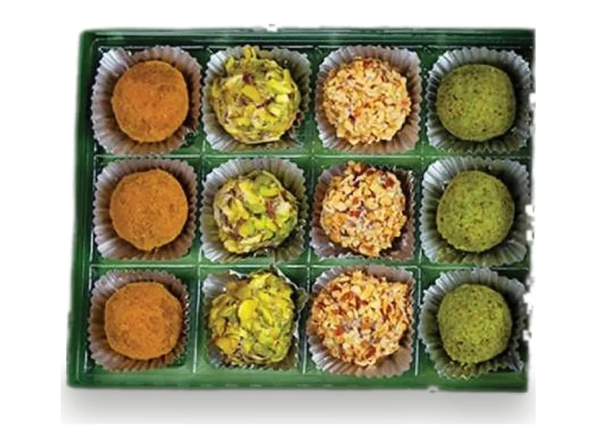 A green tray of pistachio and nut sweets