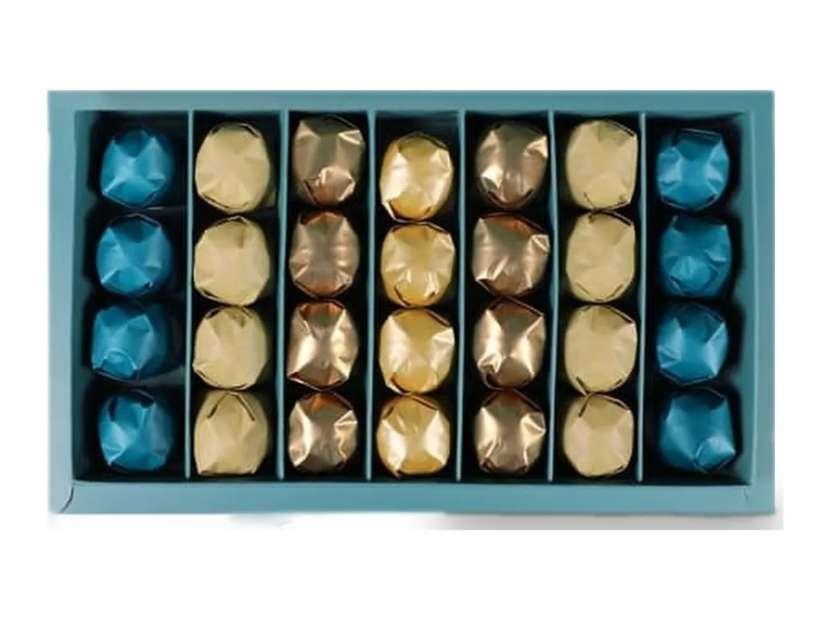 A blue box of gold and teal foil-wrapped chocolates