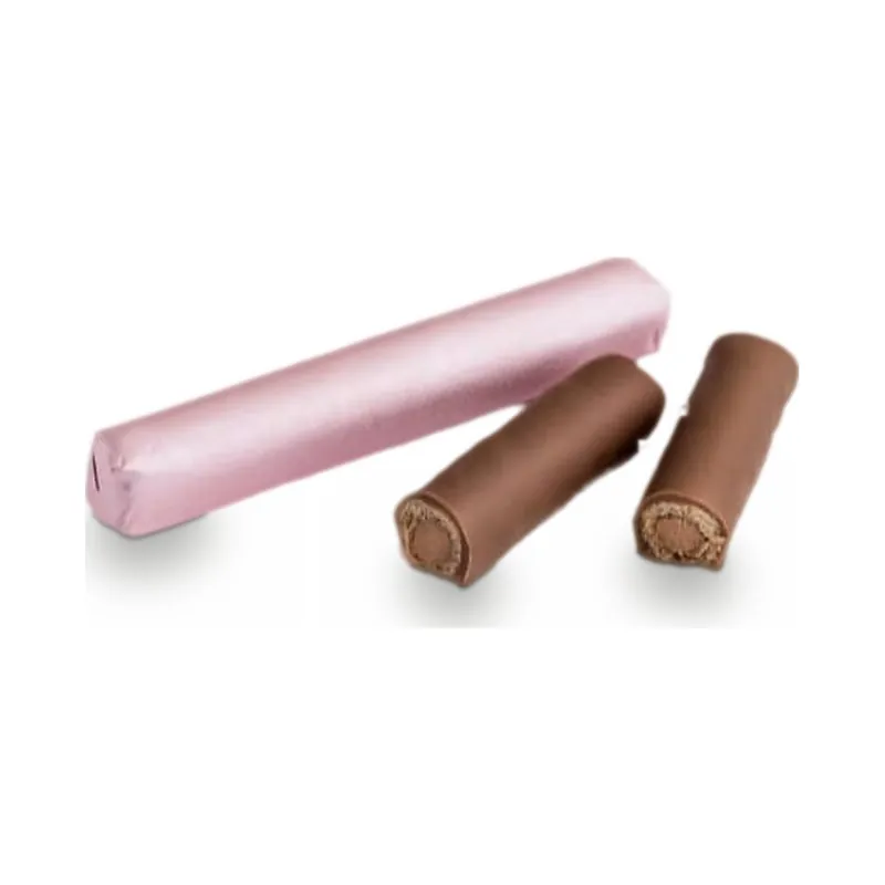 A pink foil-wrapped stick beside chocolate rolls