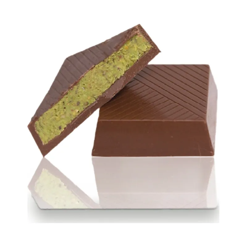 A chocolate square cut to show a pistachio filling